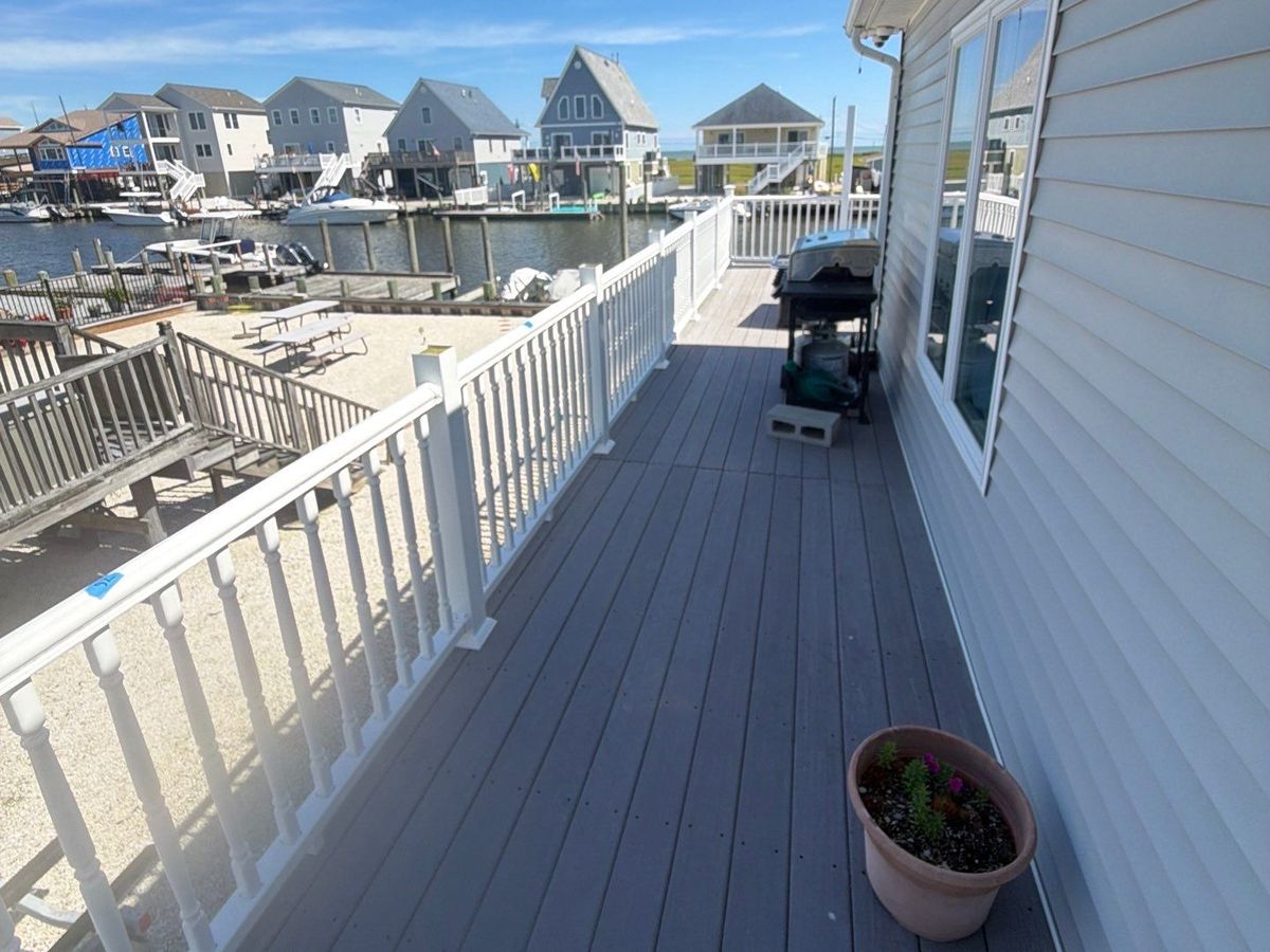 Vinyl railing installed along a long waterfront deck