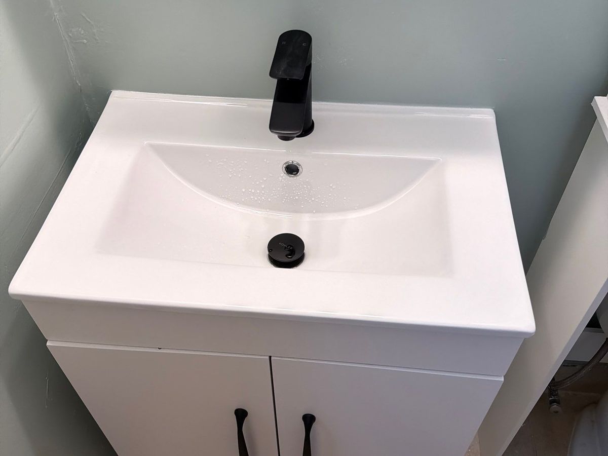 New white vanity with matte black faucet and hardware